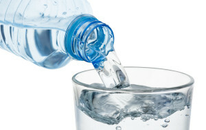 Pouring Glass Of Water From A Plastic Bottle Isolated On White B